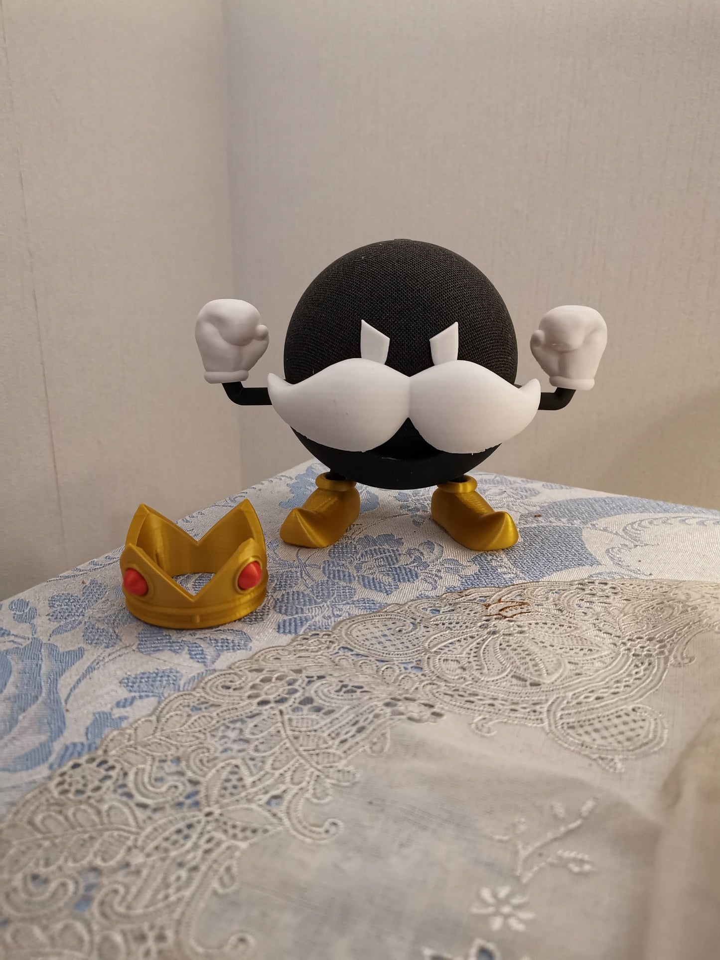 Bomb-omb Alexa Echo holder with crown next to it