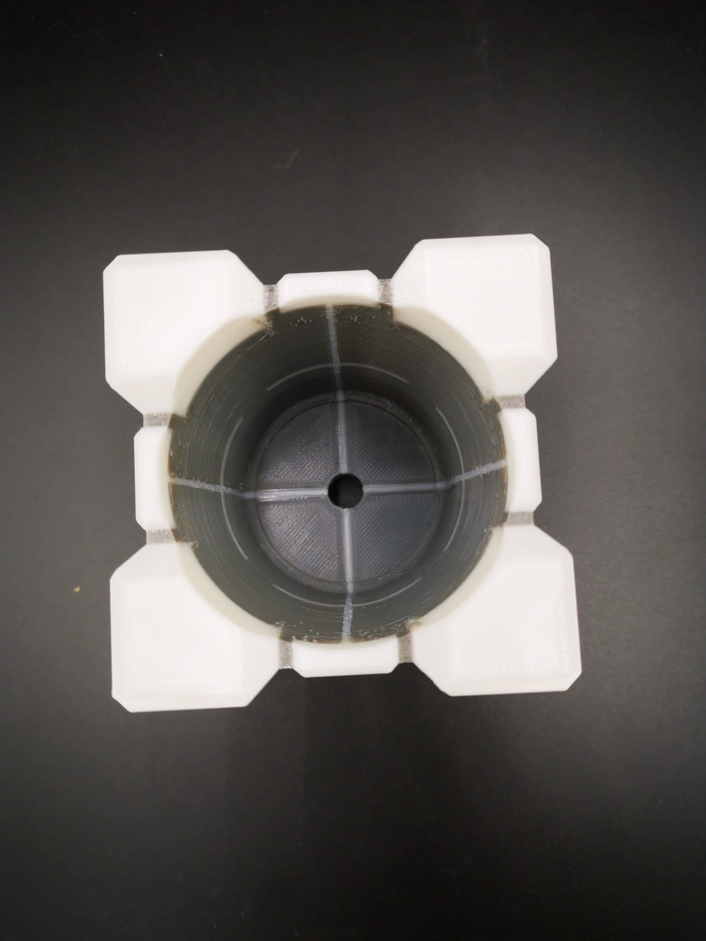 Small Companion Cube Portal planter drainage holes close up