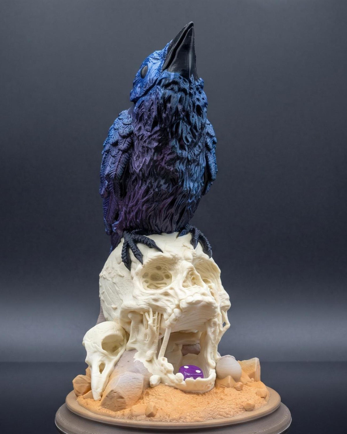 Full Colour raven skull dice tower on a dark background