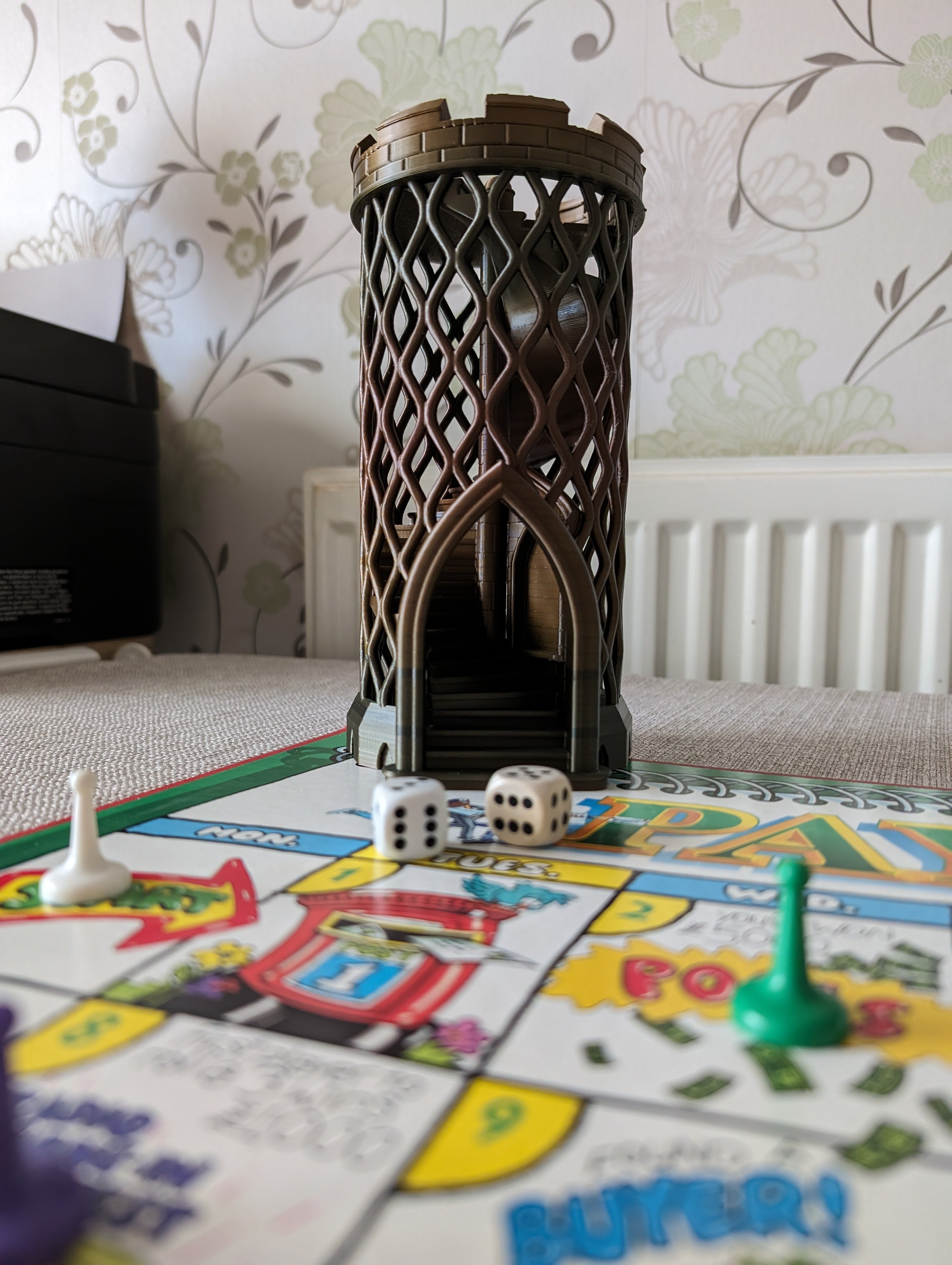 Castle turret dice tower without dice catcher next to board game