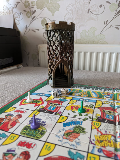 Castle turret dice tower without dice catcher next to board game wide angle