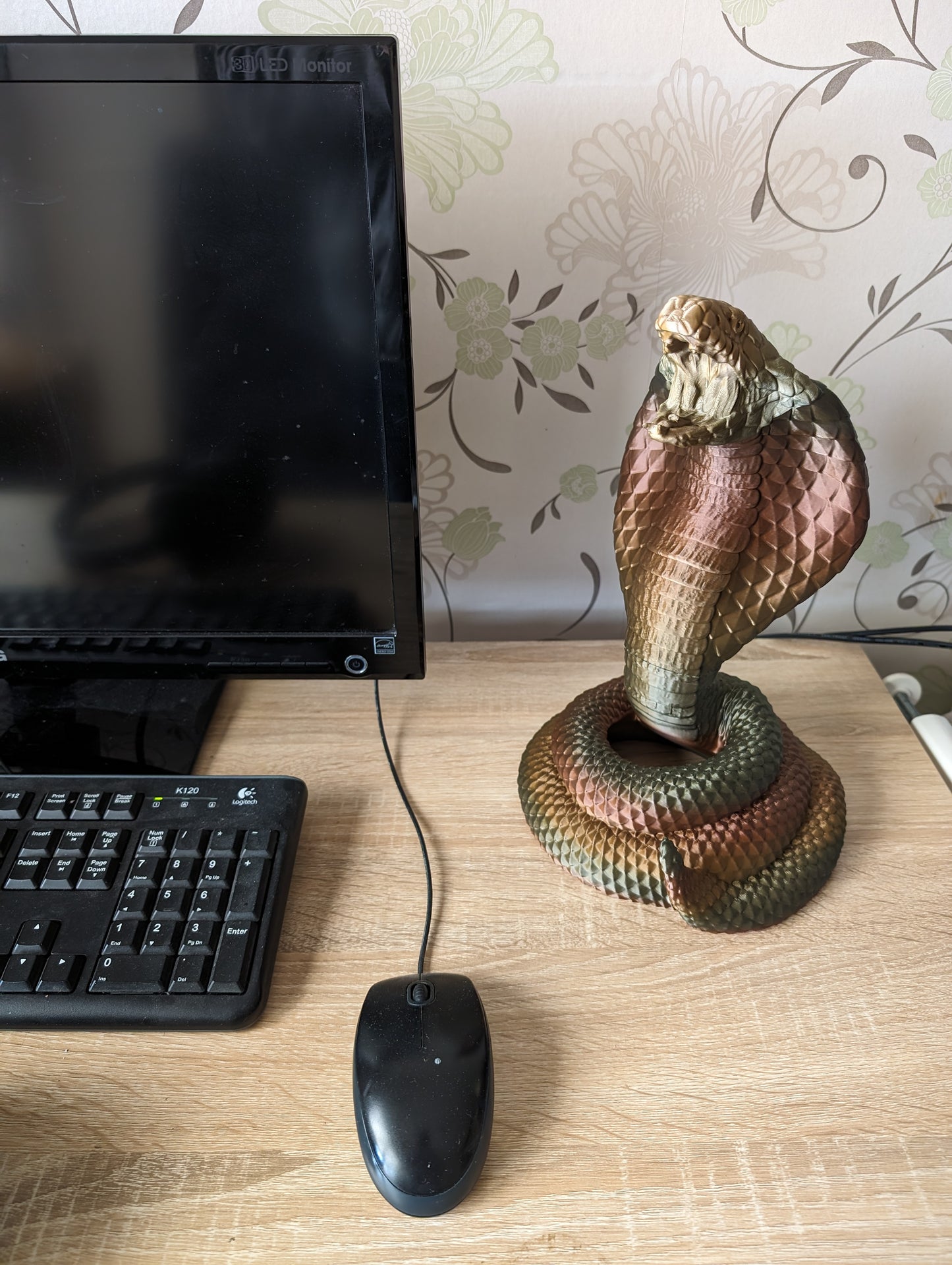 Cobra snake headphone holder on desk from front angle