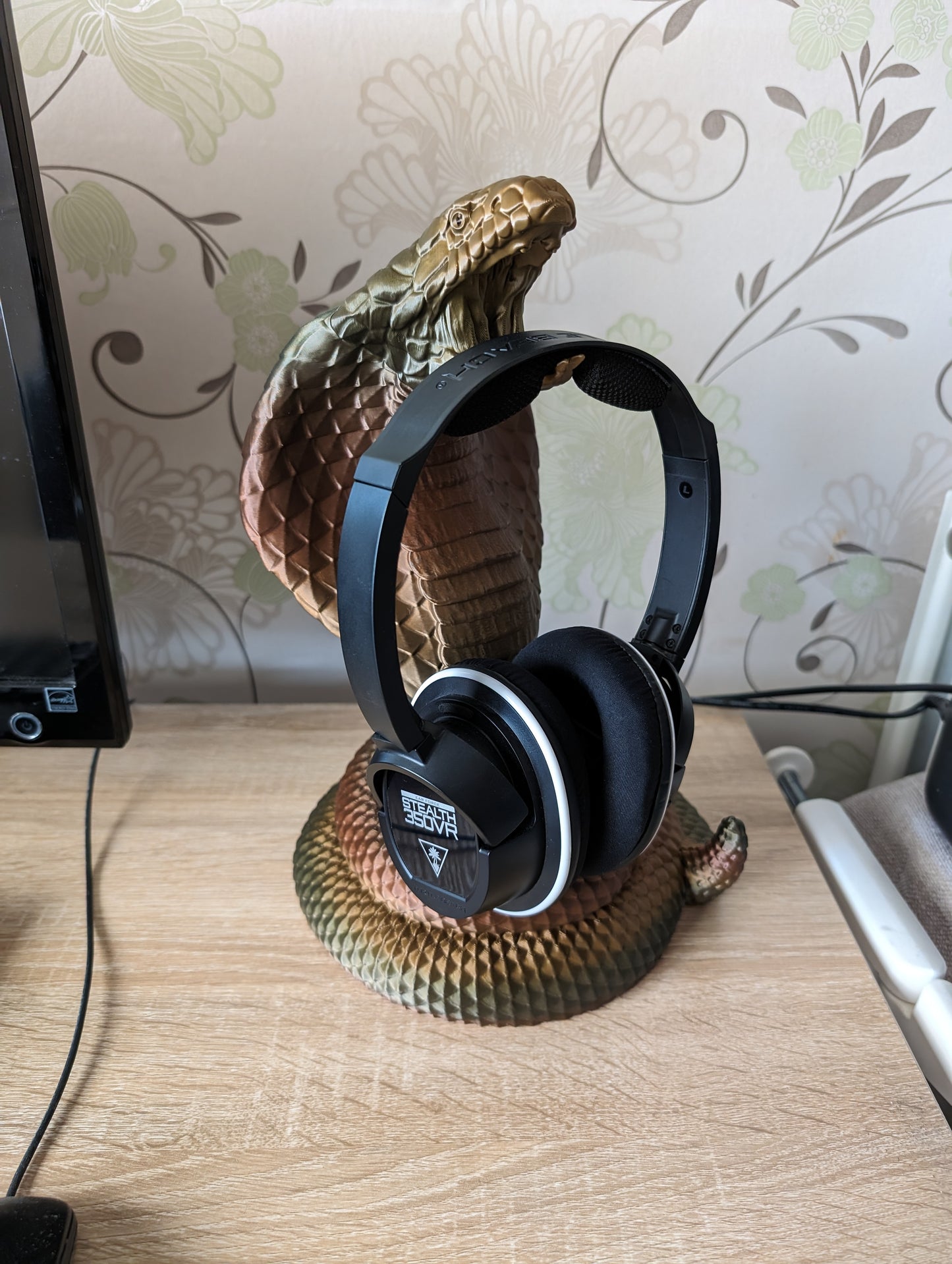 Cobra snake headphone holder on desk from side angle