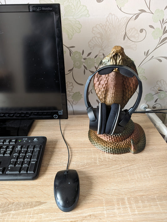 Cobra snake headphone holder on desk from the front