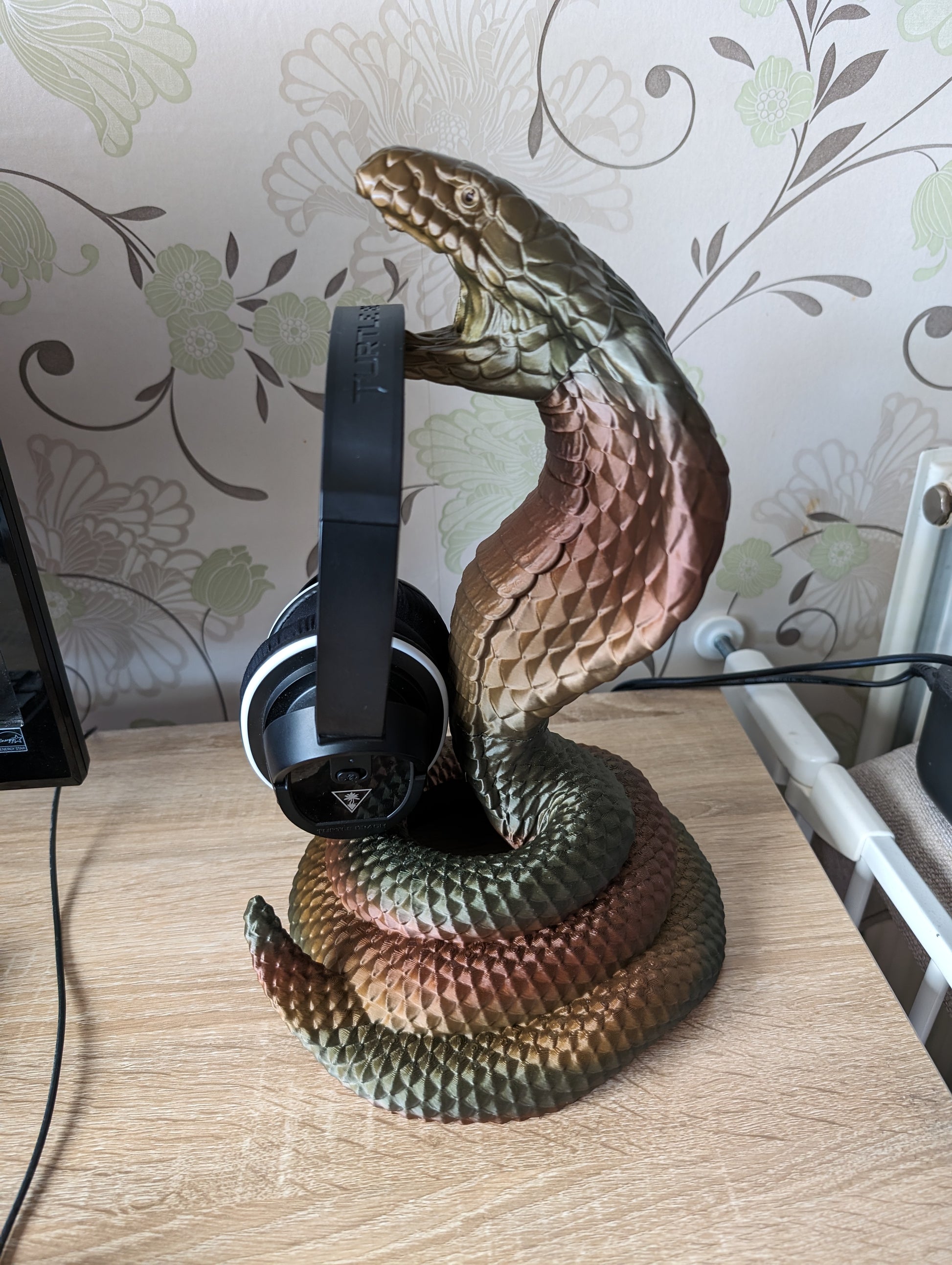 Cobra snake headphone holder on desk from the side