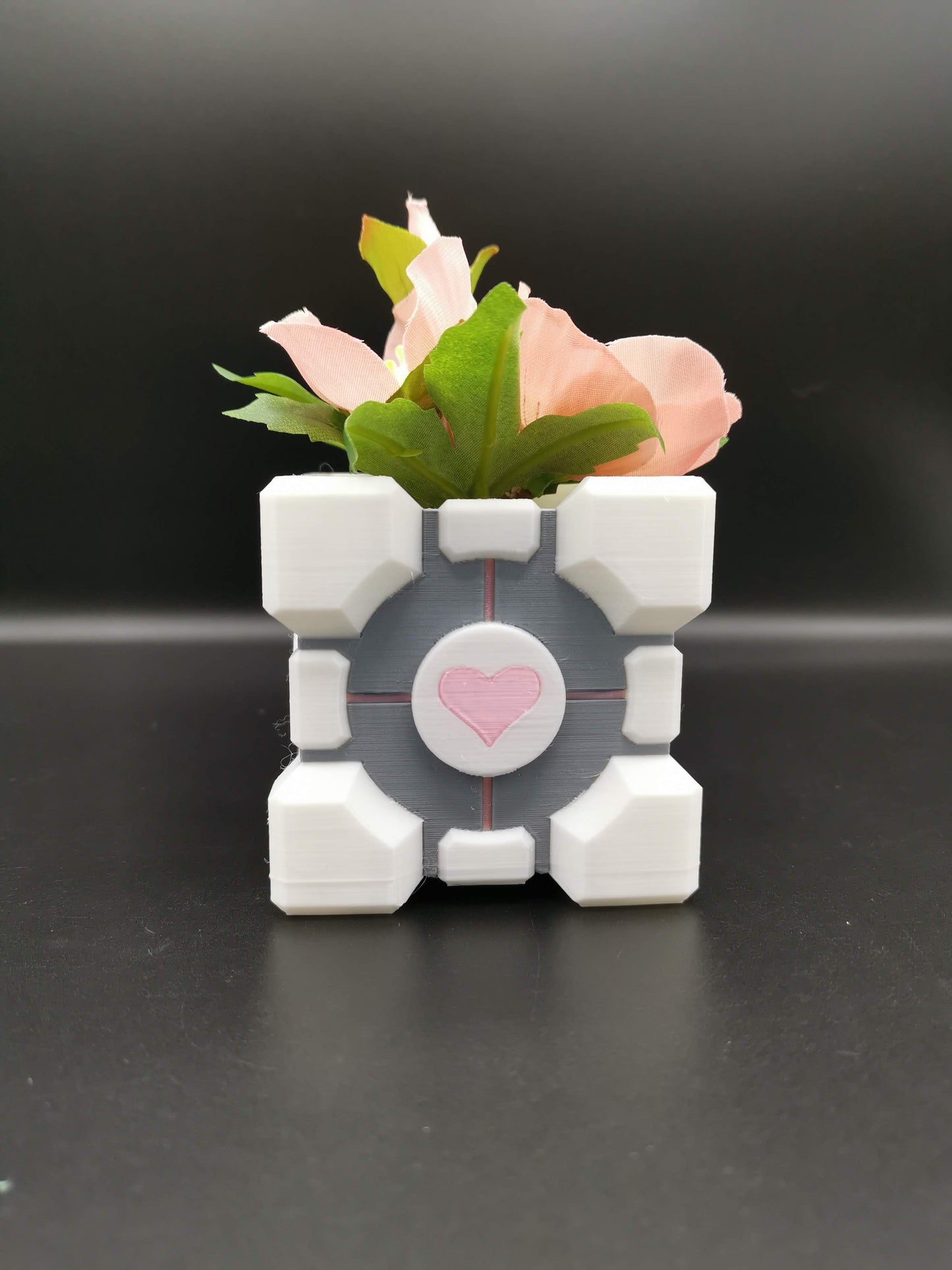 Companion Cube Portal planter close up from front with plant