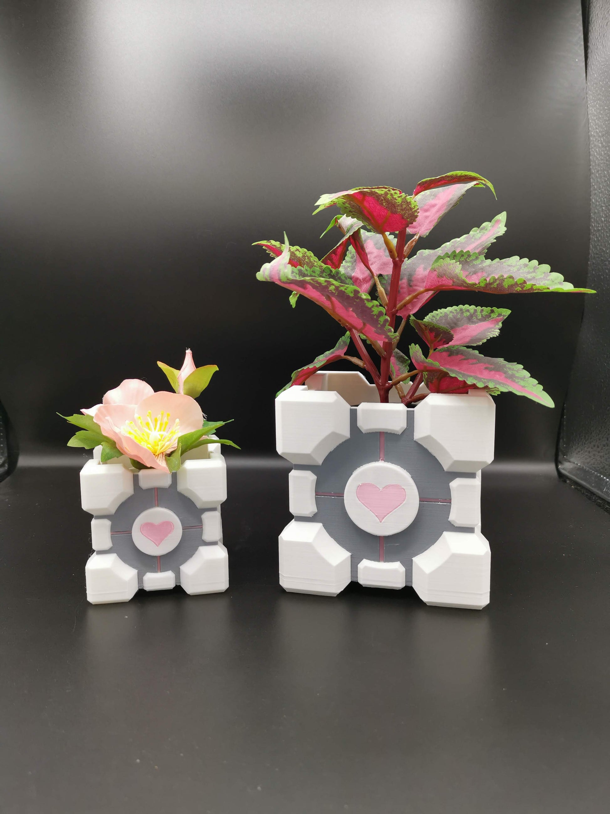 Companion Cube Portal planters in two sizes with plants