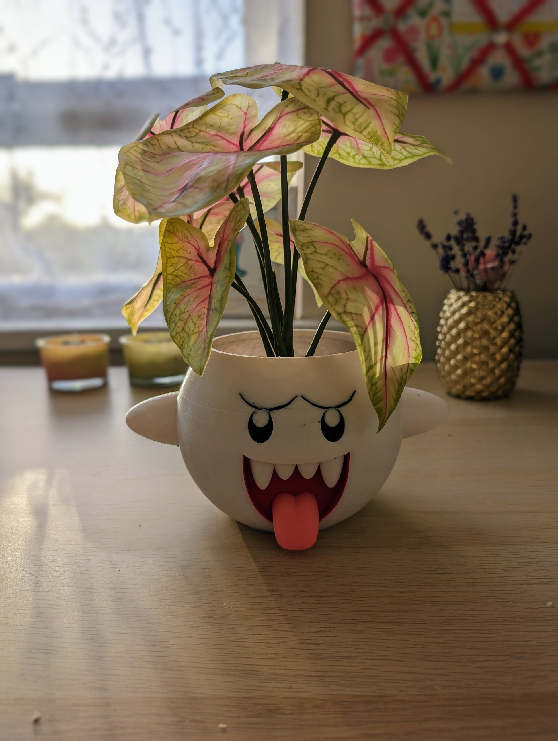 Mario Boo planter from the front with plant on desk