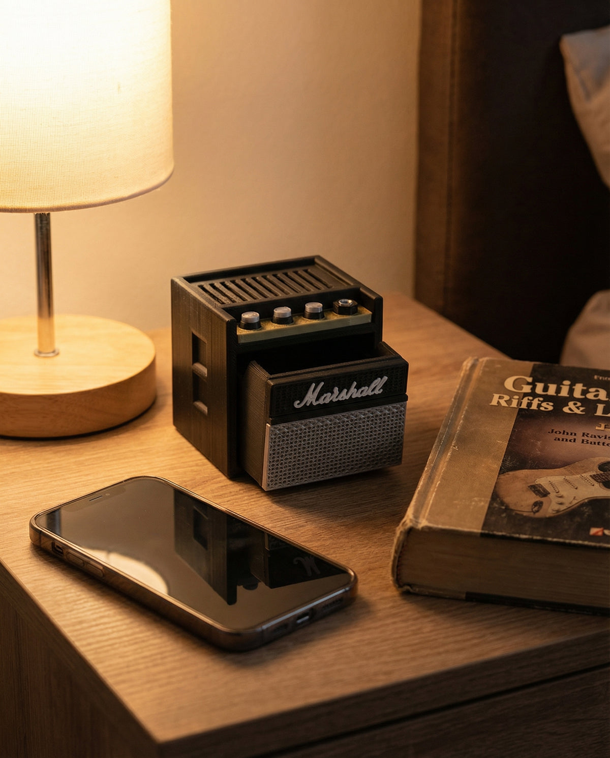 Mini guitar amp pick holder with drawer open on a bedside table