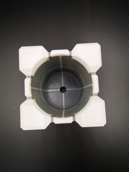 Small Companion Cube Portal planter drainage holes close up