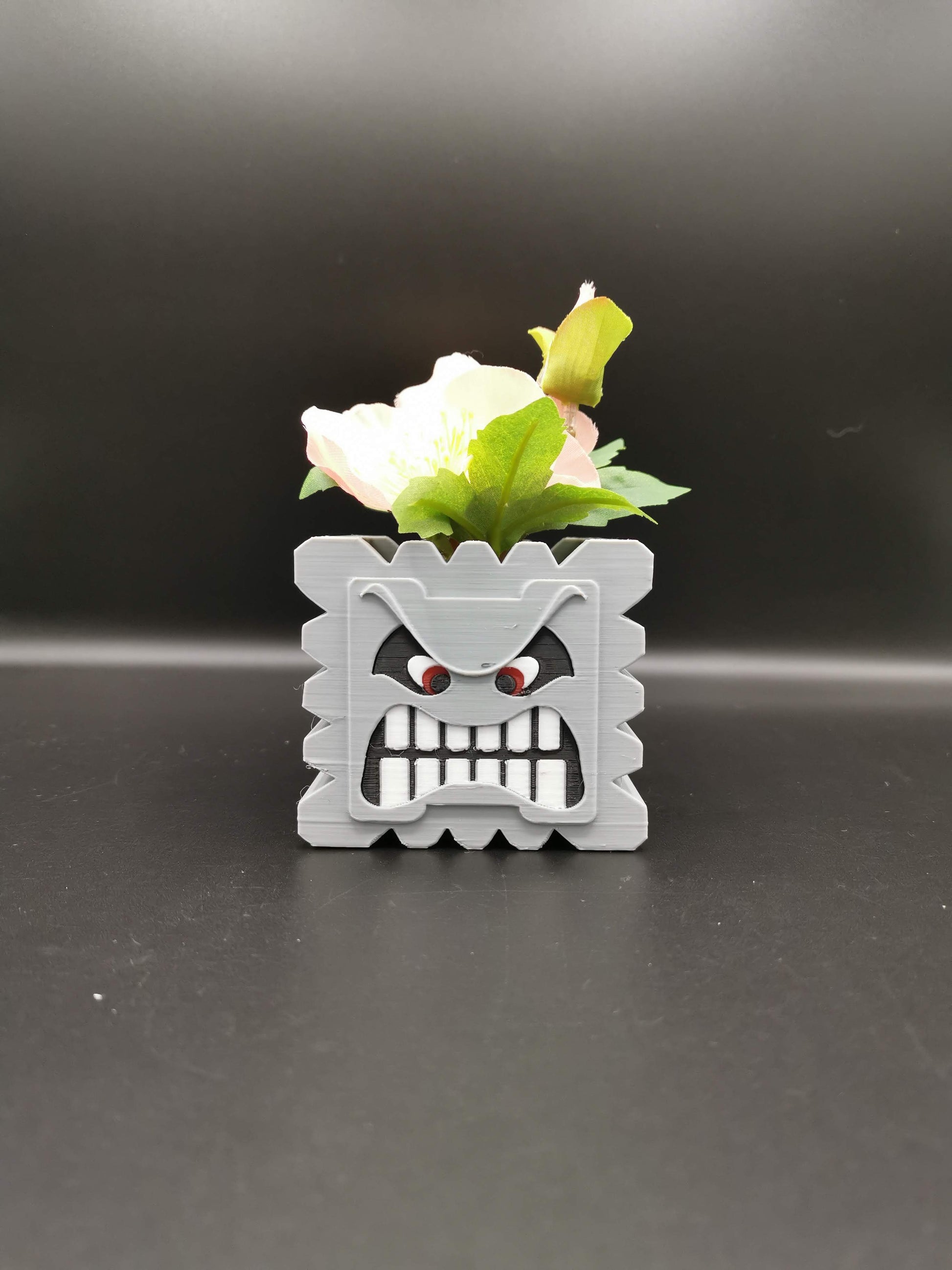 Thwomp Mario planter with plant from the front