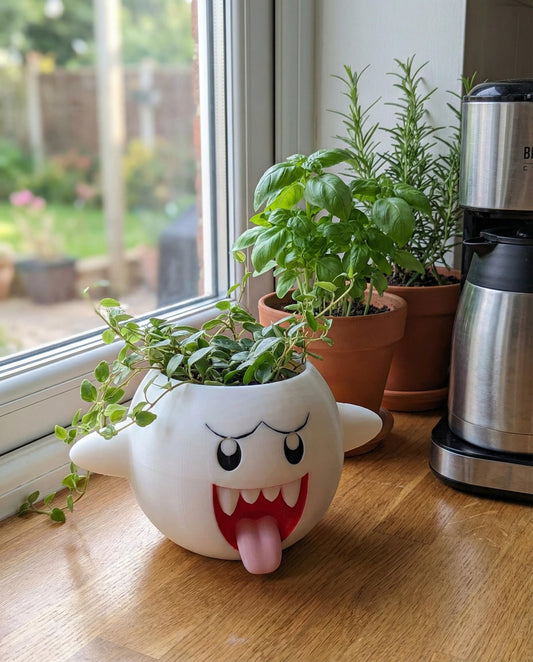 Super Mario Boo planter with succulents on a kitchen counter by the window