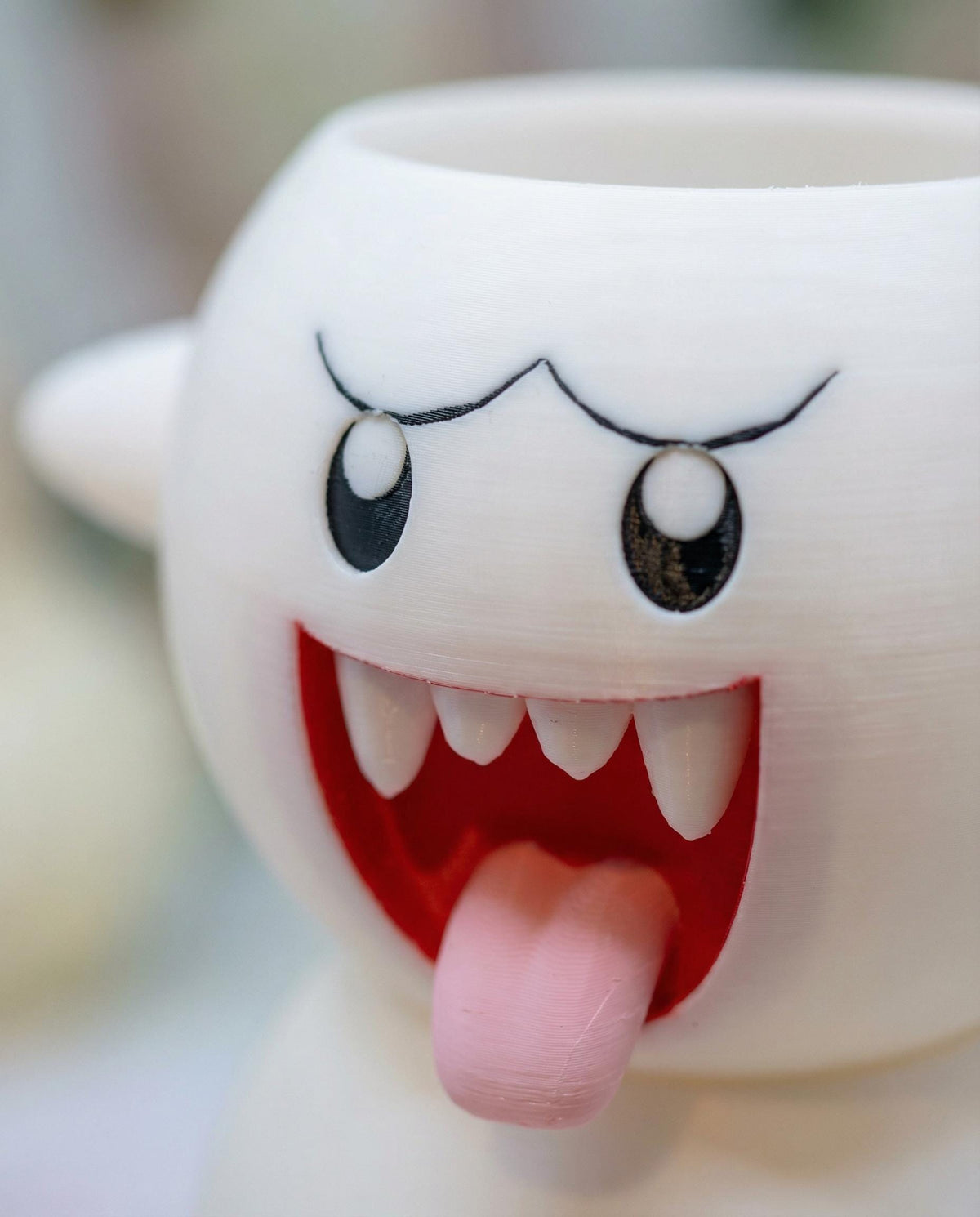 Close up of the Boo planter face, printed in multi colour with pink tongue