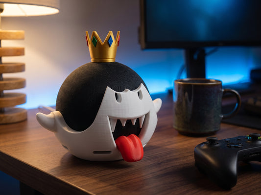 King Boo Echo Dot stand with crown on a gaming desk next to a controller