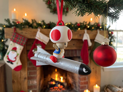 Mario Missile Toad hanging by a Christmas fireplace with stockings