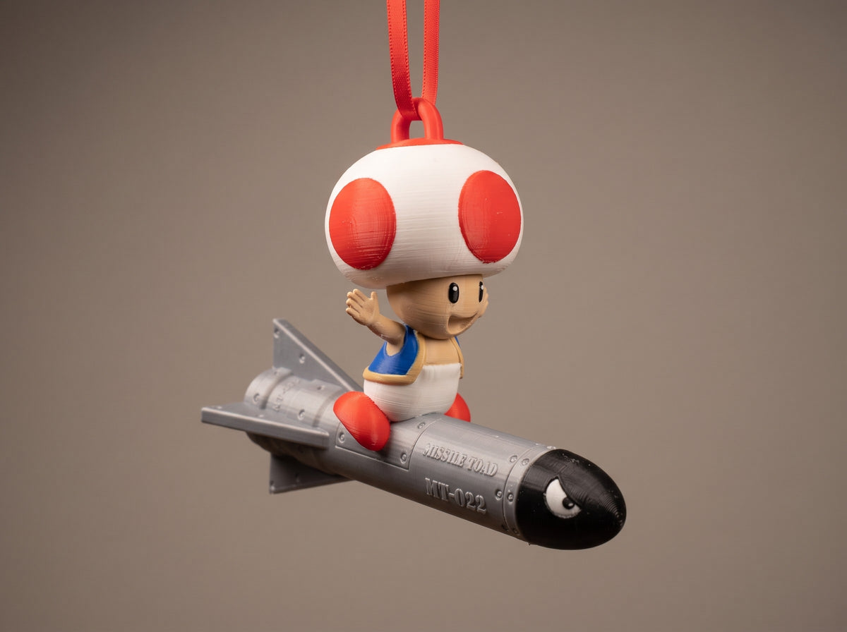 Mario Missile Toad Full Colour ornament hanging on a red ribbon