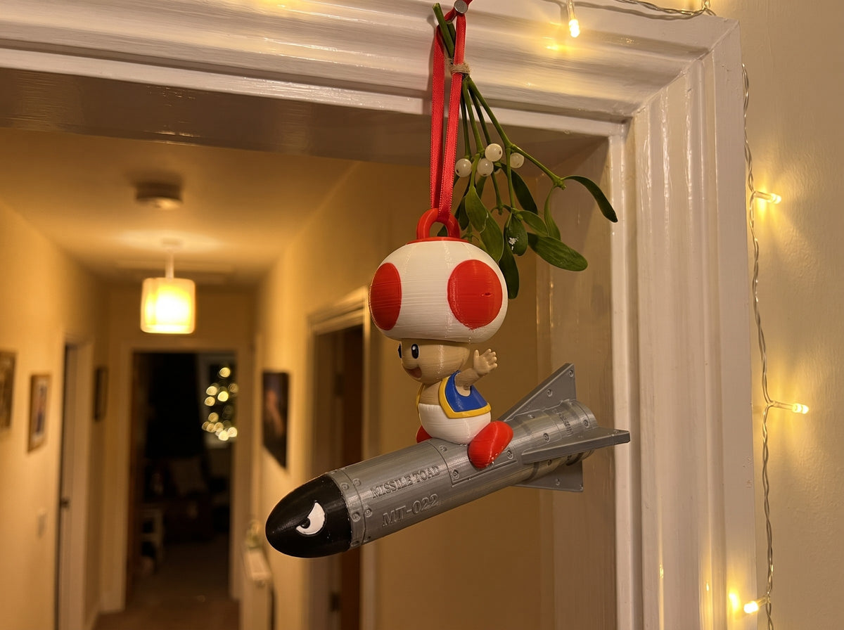 Mario Missile Toad hanging in a doorway under mistletoe
