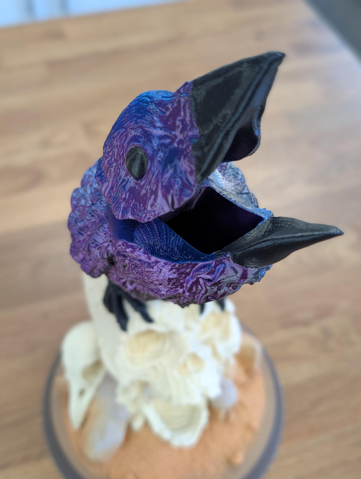 Close-up of the raven's open beak, where the dice go in