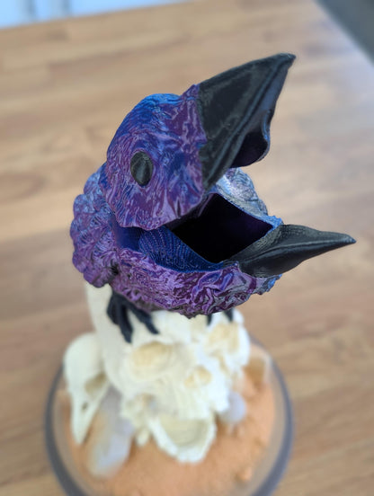 Close-up of the raven's open beak, where the dice go in