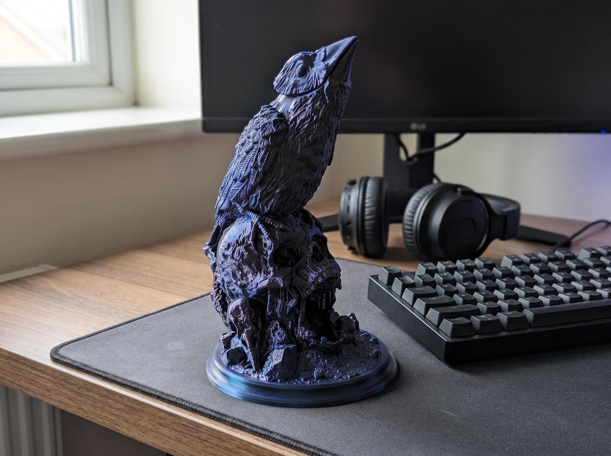 Raven dice tower on a gaming desk next to a keyboard